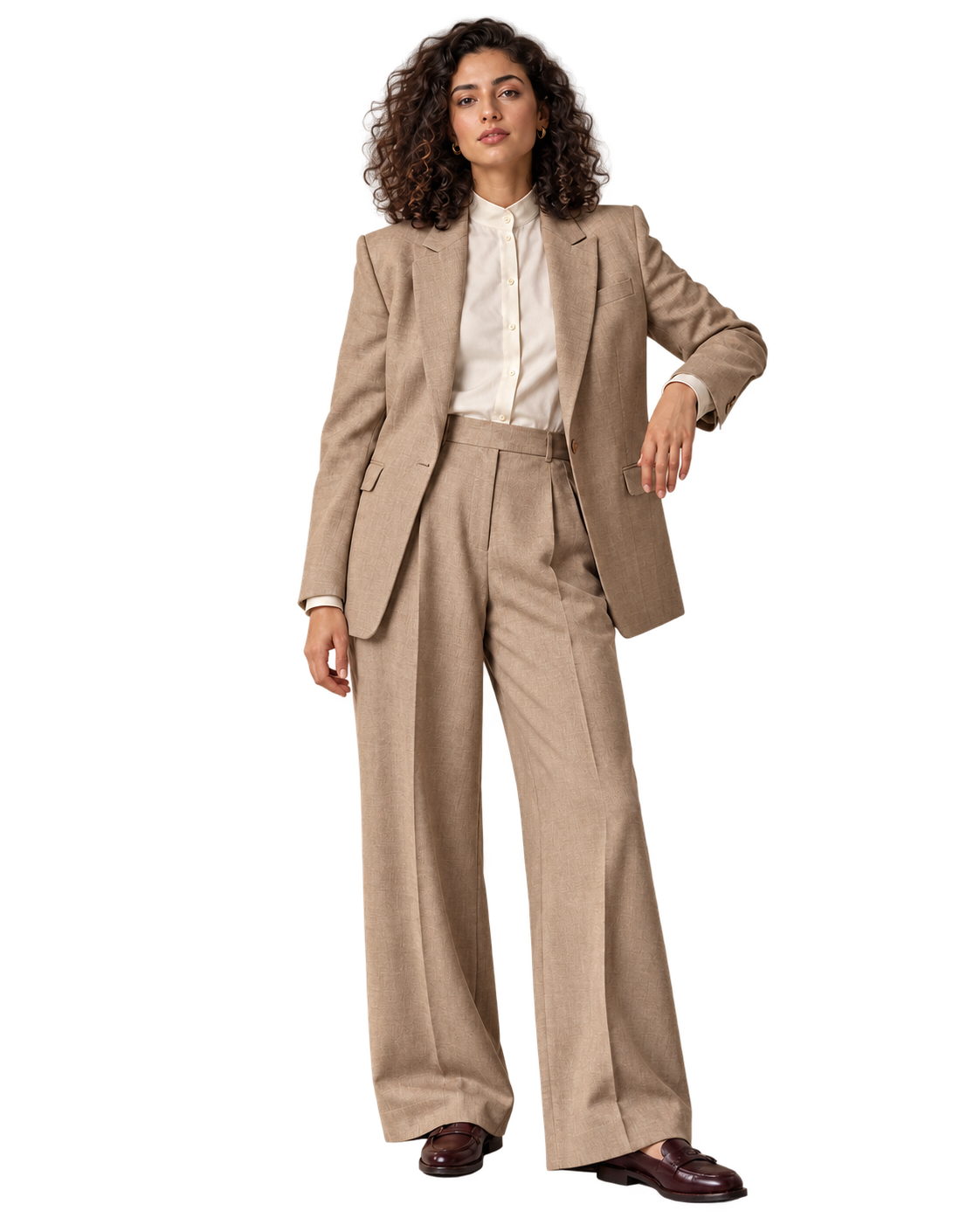 A woman in soft sand tailoring and an ivory blouse