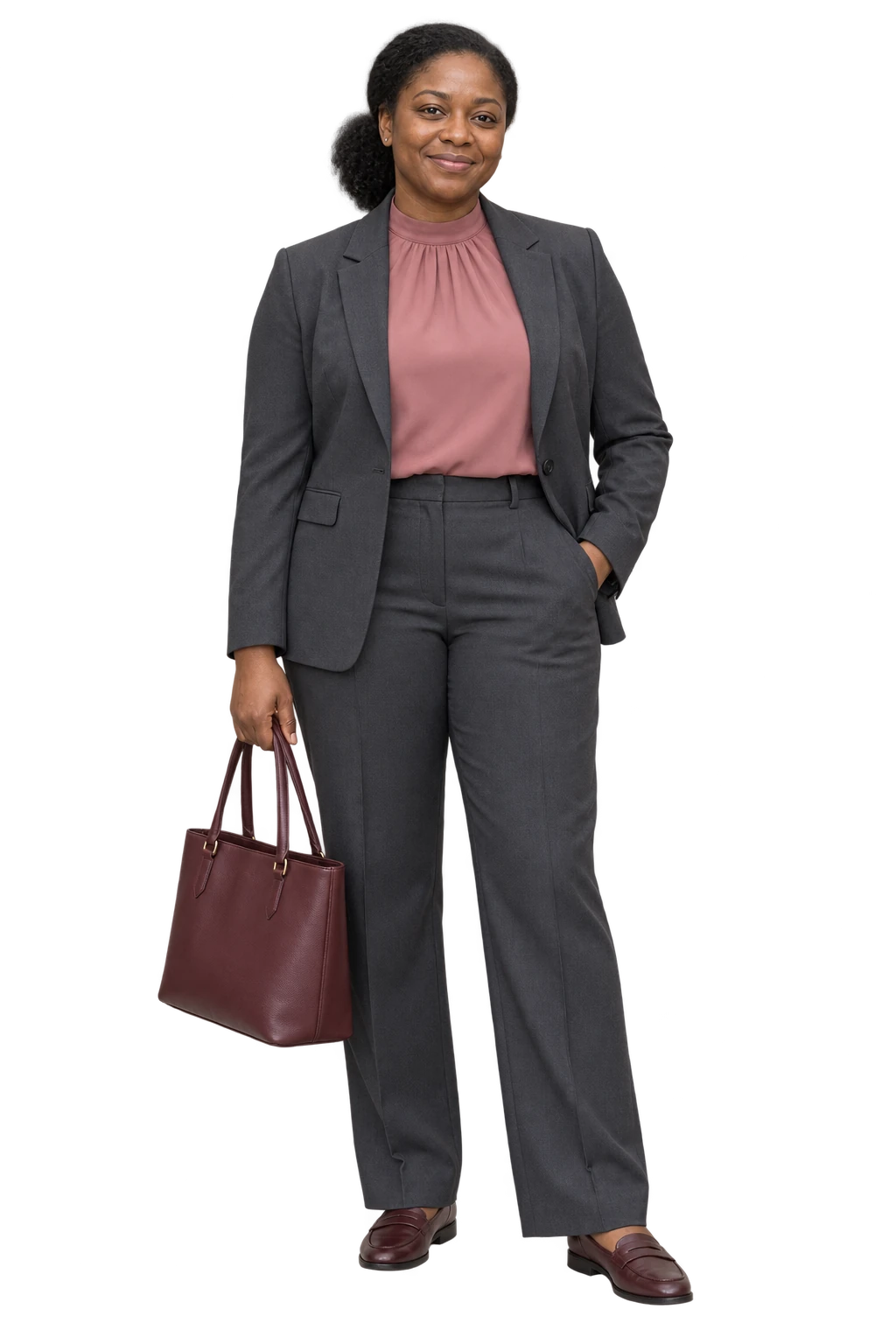 A woman wearing a charcoal trouser suit over a muted rose high-neck blouse with burgundy loafers