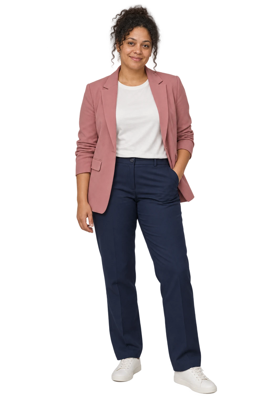 A woman in a rose blazer, ivory crew-neck top, navy straight trousers and simple trainers
