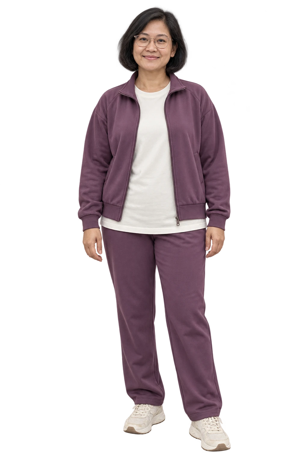 A woman in a plum zip jacket and straight-leg joggers with an ivory long tee and trainers